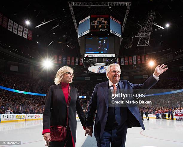 Glen Sather and Ann Sather leave the ice following the banner raising ceremony prior to the game between the Edmonton Oilers and New York Rangers on...