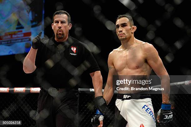 Referee John McCarthy deducts a point from Tony Ferguson for an illegal kick against Edson Barboza in their lightweight bout during the TUF Finale...