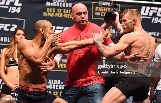Featherweight champion Jose Aldo of Brazil and interim UFC featherweight champion Conor McGregor of Ireland face off during the UFC 194 weigh-in...