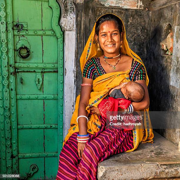 young indian woman breastfeeding her newborn baby, amber, india - rajasthani women stock pictures, royalty-free photos & images