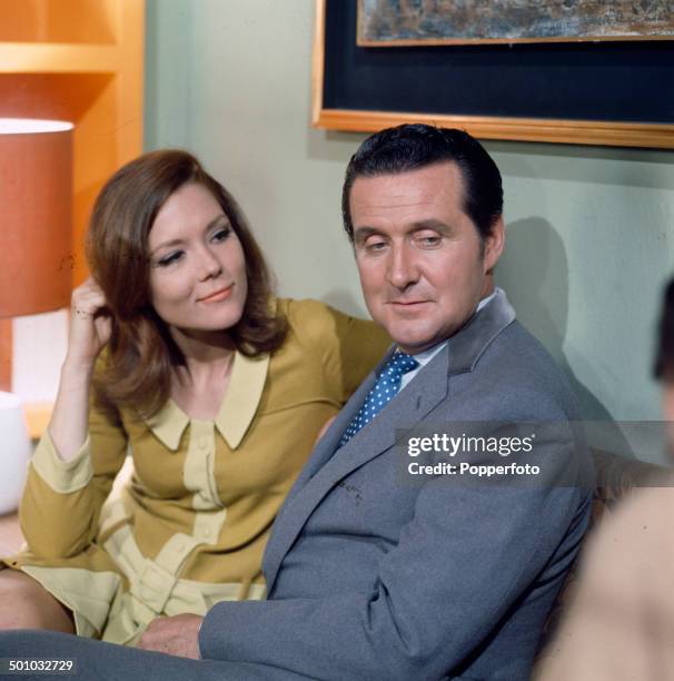 English actors Diana Rigg as 'Emma Peel' and Patrick Macnee as 'John Steed' pictured during the filming of the television series 'The Avengers' in...