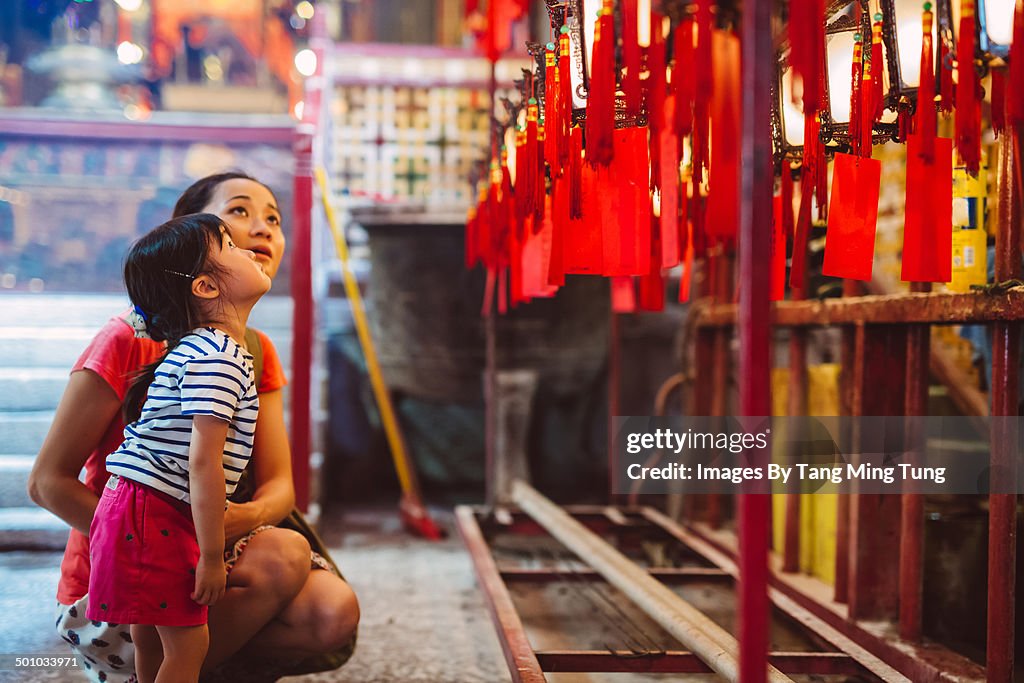 Mom & child admiring lanterns in Chinese temple