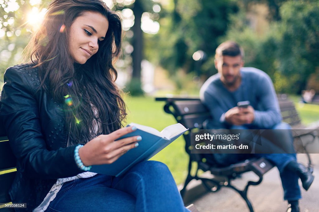 Man looking with curiosity at girl in the park