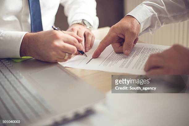 business man signing a contract - law stock pictures, royalty-free photos & images