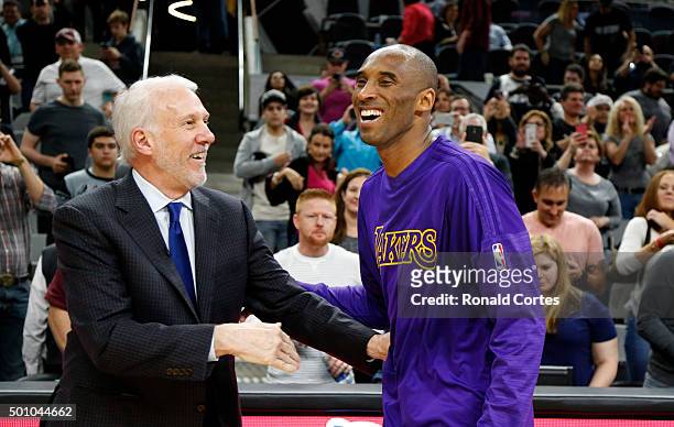 Kobe Bryant of the Los Angeles Lakers talks with head coach Gregg Popovich of the San Antonio Spurs at the end of the game at AT&T Center on December...