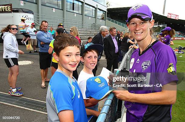 Julie Hunter of the Hurricanes signs autographs for supporters in the crowd after the Women's Big Bash League match between the Hobart Hurricanes and...