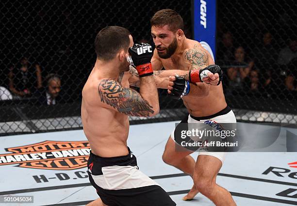 Frankie Edgar punches Chad Mendes in their featherweight bout during the TUF Finale event inside The Chelsea at The Cosmopolitan of Las Vegas on...