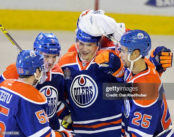 Lauri Korpikoski of the Edmonton Oilers is mobbed by teammates after scoring a hat trick against the New York Rangers at Rexall Place on December 11,...