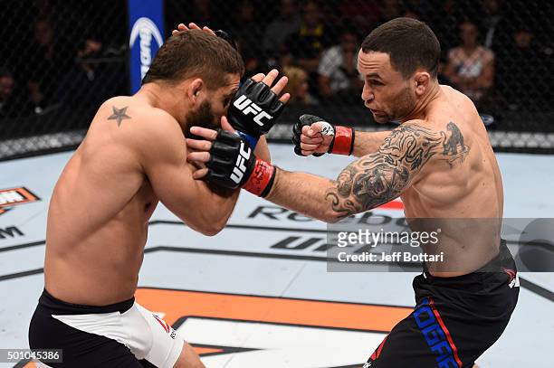 Frankie Edgar punches Chad Mendes in their featherweight bout during the TUF Finale event inside The Chelsea at The Cosmopolitan of Las Vegas on...