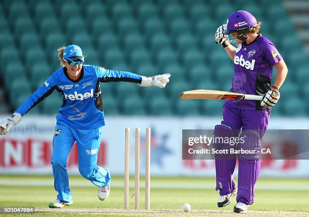 Corinne Hall of the Hurricanes is bowled out as wicketkeeper Sarah Taylor of the Strikers looks on during the Women's Big Bash League match between...