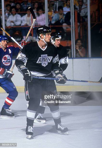 Mike Krushelnyski of the Los Angeles Kings skates on the ice during an NHL game against the Winnipeg Jets circa 1990 at the Great Western Forum in...