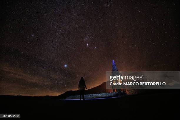 Photographer prepares to take pictures of the annual Geminid meteor shower on the Elva Hill, in Maira Valley, near Cuneo, northern Italy on December...
