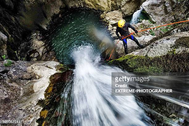 rappeling down the waterfall - canyoning stock pictures, royalty-free photos & images