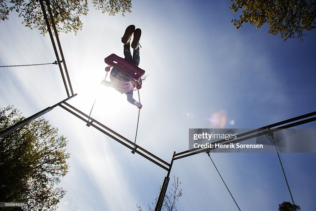 Young girl on a swing