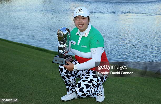 Shanshan Feng of China proudly holds the trophy after her victory in the final round of the 2015 Omega Dubai Ladies Masters on the Majlis Course at...