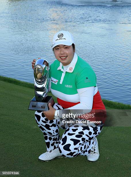 Shanshan Feng of China proudly holds the trophy after her victory in the final round of the 2015 Omega Dubai Ladies Masters on the Majlis Course at...