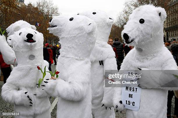 Environmentalist dressed in bear costumes demonstrate during the World Climate Change Conference 2015 on December 12, 2015 in Paris, France. The...