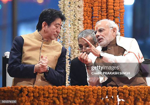 Japan's Prime Minister Shinzo Abe and India's Prime Minister Narendra Modi talk as they watch the evening 'Aarti' ritual on the banks of the River...