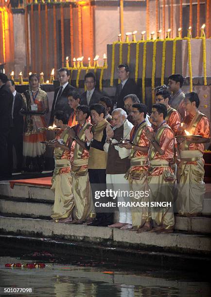 Japan's Prime Minister Shinzo Abe and India's Prime Minister Narendra Modi pray during the evening 'Aarti' ritual on the banks of the River Ganges at...