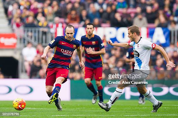 Andres Iniesta of FC Barcelona passes th ball next to Alex Bergantinos of RC Deportivo La Coruna during the La Liga match between FC Barcelona and RC...