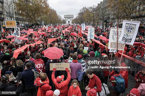 Thousands of activists gather during a demonstration near the Arc de Triomphe at the Avenue de la Grande Armee boulevard on December 12, 2015 in...