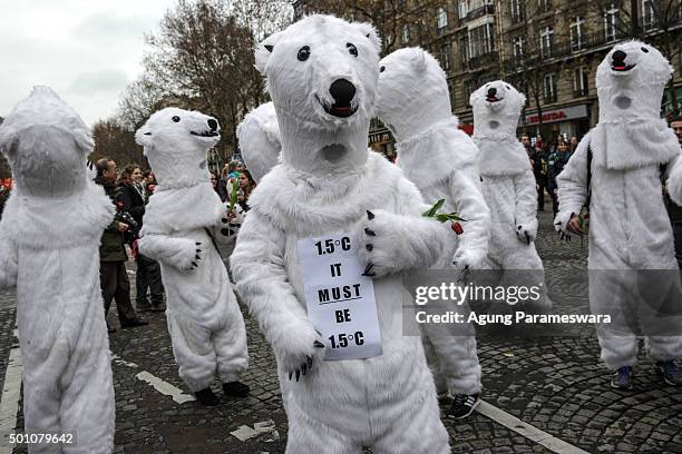 Activists wear polar bear costumes during a demonstration at the Avenue de la Grande Armee boulevard on December 12, 2015 in Paris, France. The final...