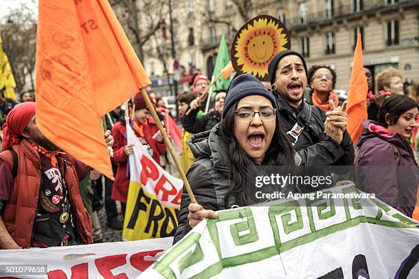 An activist shouts during a demonstration near the Arc de Triomphe at the Avenue de la Grande Armee boulevard on December 12, 2015 in Paris, France....