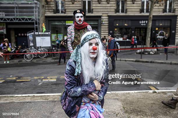 Two activists perform during a demonstration near the Arc de Triomphe at the Avenue de la Grande Armee boulevard on December 12, 2015 in Paris,...