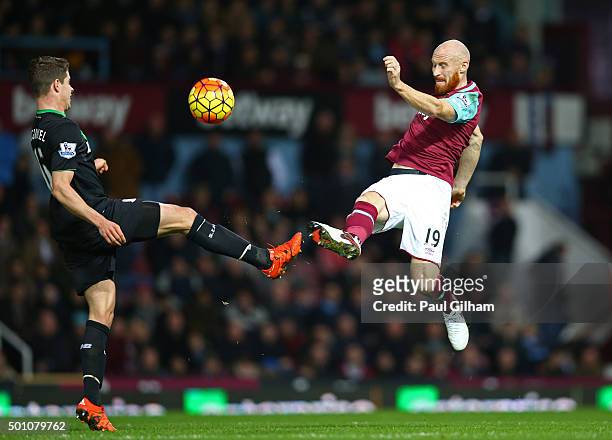 James Collins of West Ham United and Marco van Ginkel of Stoke City compete for the ball during the Barclays Premier League match between West Ham...