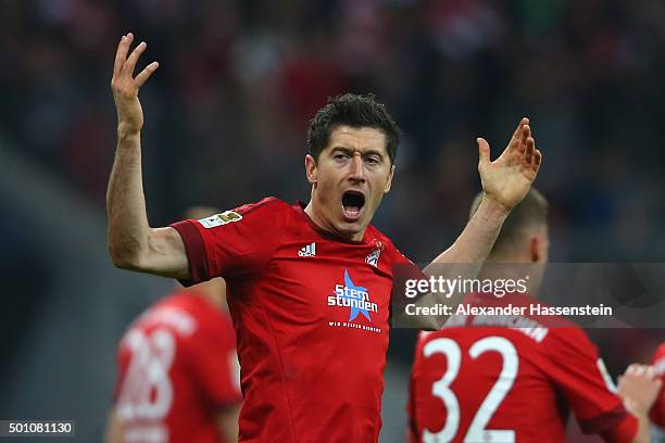 Robert Lewandowski of Muenchen celebrates scoring the opening goal during the Bundesliga match between FC Bayern Muenchen and FC Ingolstadt at...