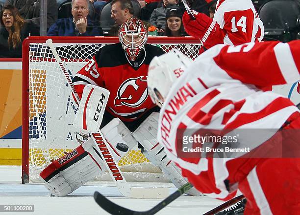 Niklas Kronwall of the Detroit Red Wings fires a shot at Cory Schneider of the New Jersey Devils at the Prudential Center on December 11, 2015 in...