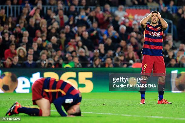 Barcelona's Argentinian forward Lionel Messi and FC Barcelona's Uruguayan forward Luis Suarez gesture after missing a goal during the Spanish league...
