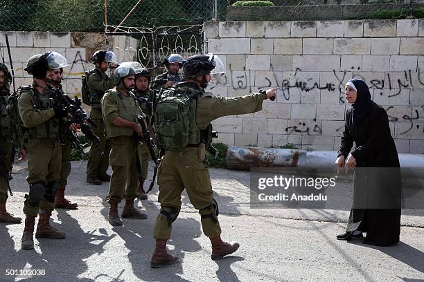 Israeli soldiers intervene to Palestinian woman during a protest after Israel closed the entrance of Aboud village with soil in Ramallah, West Bank...