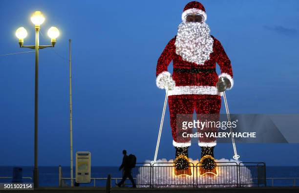 Giant illuminated Santa Claus model is displayed along the "Promenade des Anglais" in the French Riviera city of Nice, southeastern France, on...