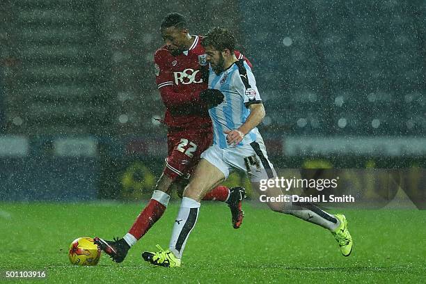 Martin Cranie of Huddersfield Town FC and Jonathan Kodjia of Bristol City FC compete for the ball during the Sky Bet Championship match between...