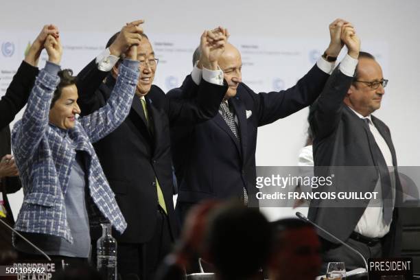In this picture taken on December 12, 2015 Foreign Affairs Minister and President-designate of COP21 Laurent Fabius , raises hands with Secretary...