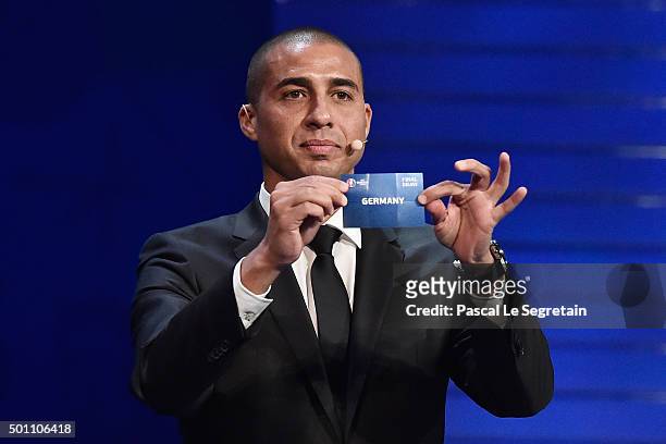 Draw assistant David Trezeguet draws out Germany in to Group C during the UEFA Euro 2016 Final Draw Ceremony at Palais des Congres on December 12,...