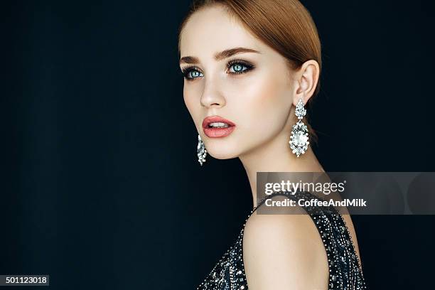 portrait of a nice looking woman with beautiful earings - jewelry stock pictures, royalty-free photos & images