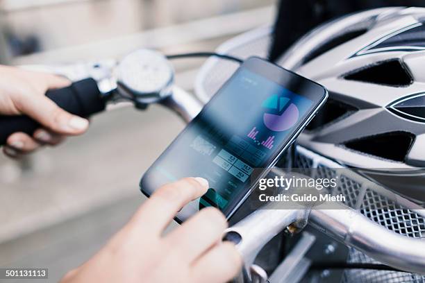 woman using self tracking app. - fahrrad lenker stock-fotos und bilder