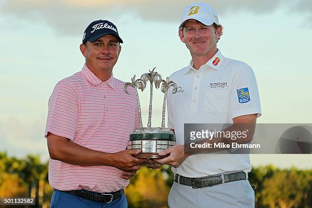 Jason Dufner and Brandt Snedeker pose with the trophy after winning the Franklin Templeton Shootout at Tiburon Golf Club on December 12, 2015 in...