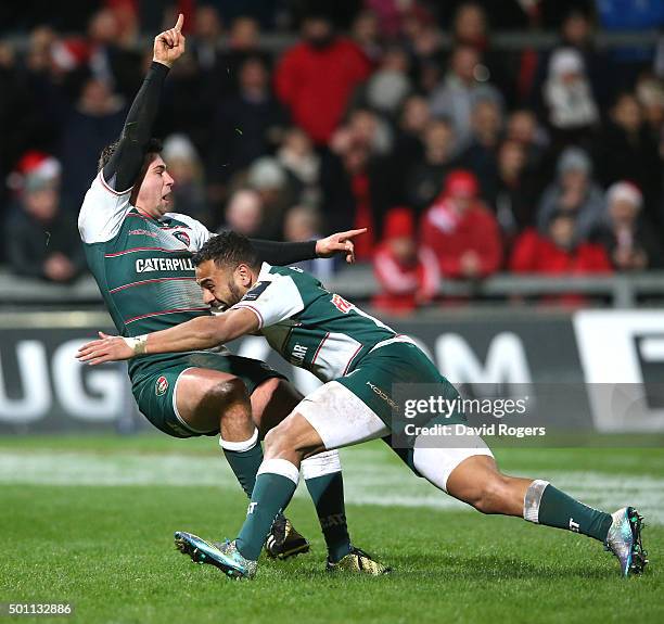 Ben Youngs of Leicester celebrates with team mate Telusa Veainu after scoring their third try during the European Rugby Champions Cup match between...