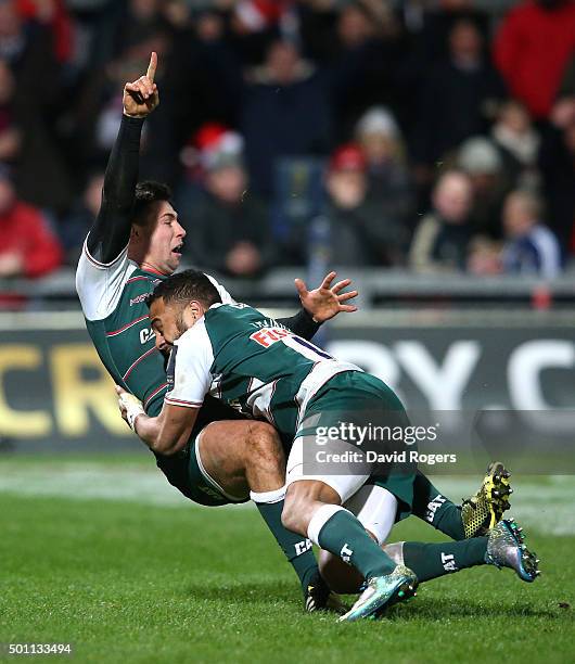 Ben Youngs of Leicester celebrates with team mate Telusa Veainu after scoring their third try during the European Rugby Champions Cup match between...