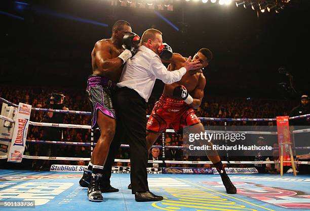 Anthony Joshua throws a punch after the bell at the end of the first round as the referee intervenes during the British and Commonwealth heavyweight...