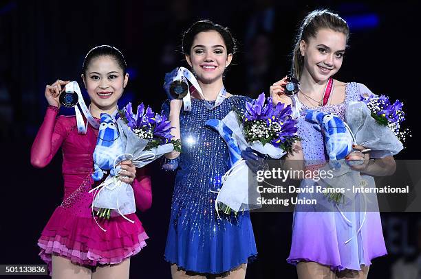 Silver medalist Satoko Miyahara of Japan, Gold medalist Evgenia Medvedeva of Russia and Bronze medalist Elena Radionova of Russia pose during the...