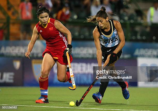 Agustina Albertarrio of Argentina is pursued by Qiuxia Cui of China during the semi final match between Argentina and China on day 8 of the Hockey...