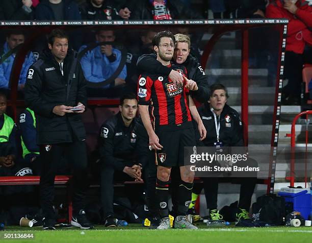Eddie Howe Manager of Bournemouth embraces Harry Arter as they stand in the technical area during the Barclays Premier League match between A.F.C....