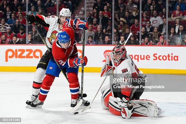 Jared Cowen of the Ottawa Senators tries to defend against Brian Flynn of the Montreal Canadiens as he tries to redirect the puck towards the net of...