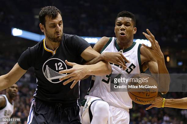 Giannis Antetokounmpo of the Milwaukee Bucks and Andrew Bogut of the Golden State Warriors scramble for a loose ball during the first quarter at BMO...
