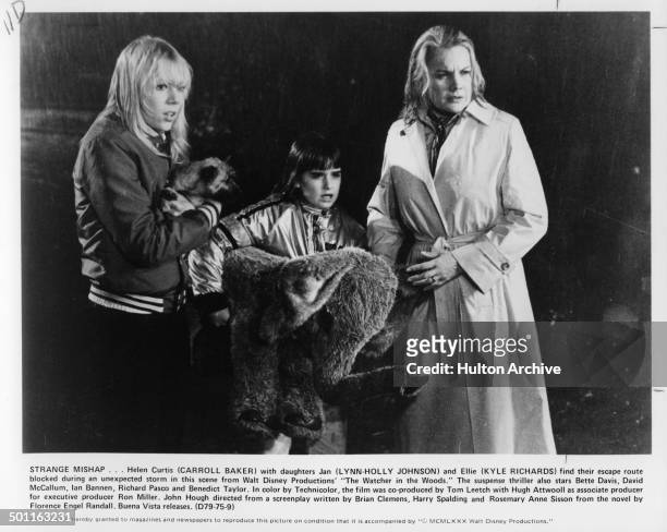 Lynn-Holly Johnson, Kyle Richards and Carroll Baker try to escape in the rain in a scene from the Walt Disney movie "The Watcher in the Woods" circa...