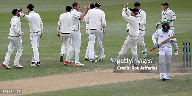 Tim Southee of New Zealand is congratulated on the dismissal of Kusal Mendis of Sri Lanka by his team-mates during day four of the First Test match...